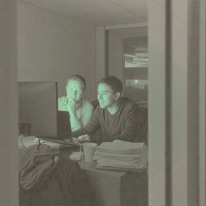 Ben helping a satisfied portfolio manager after hours, in pale paper tones with a soft green light.